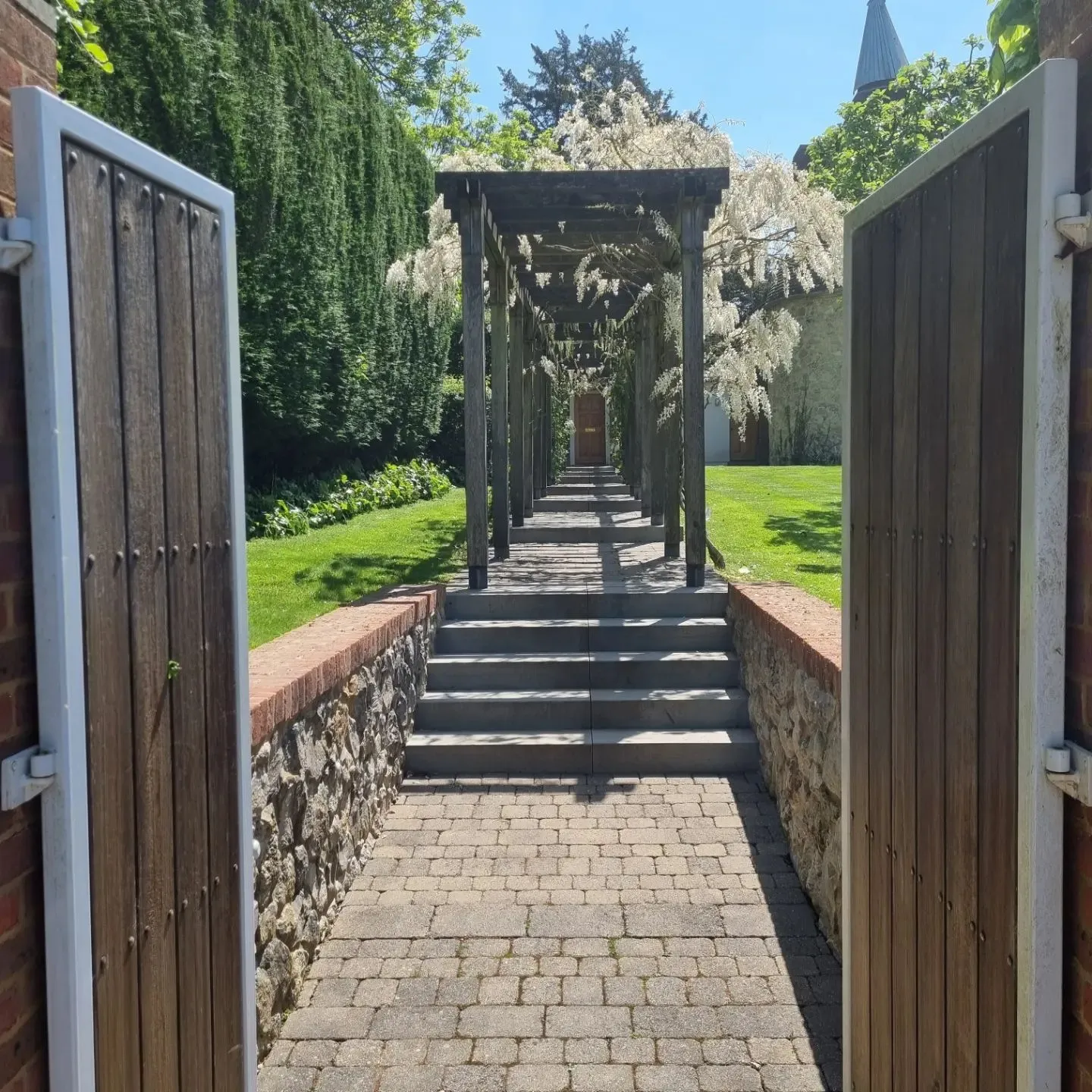 An open door leading to a garden with a walkway.